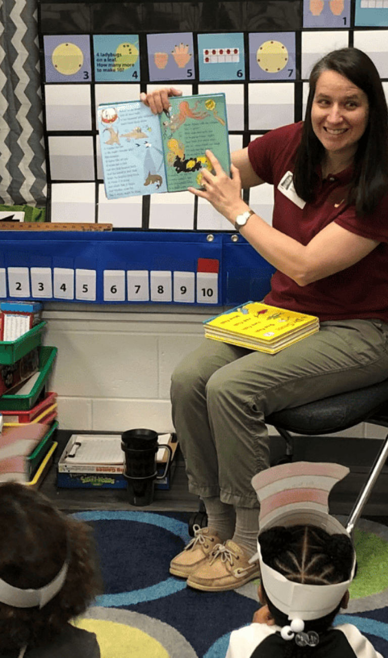 United Way volunteer reading to a kindergarten classroom